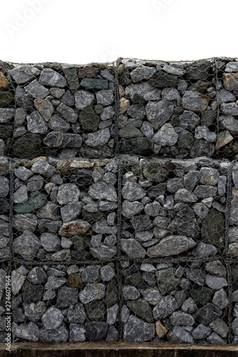 Retaining stone wall next to the road. Protection fence or wall made of gabions with stones. Stone wall with metal grid as background. stone floor texture, A wall called a gabion. on white background,