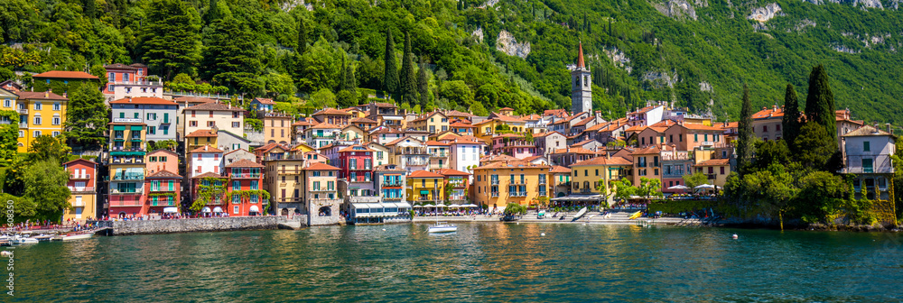 VARENNA, ITALY - June 1, 2019 - Varenna old town with the mountains in the background, Italy, Europe.