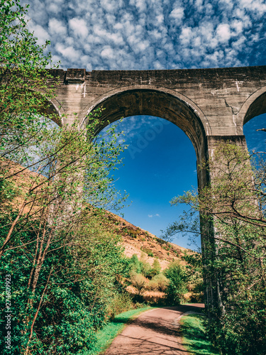 Glenfinnan viaduct and historical train in Scotland