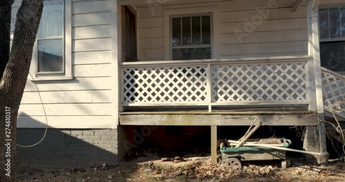 Slow dolly establishing shot of a back door entrance from a small porch