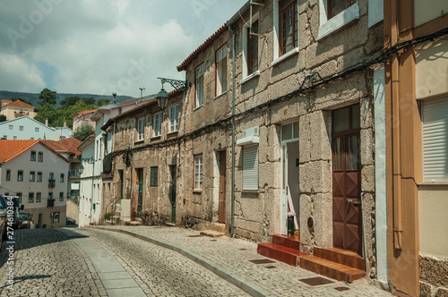 Old houses with stone wall in a deserted alley