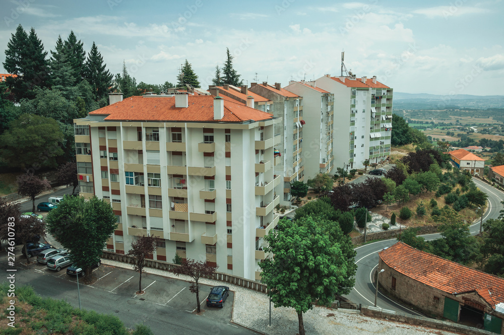 Fototapeta premium Cityscape with apartment building in the midst of trees