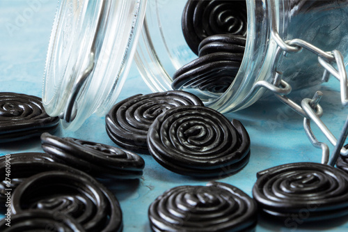 Detail of licorice candy spirals outside a glass jar