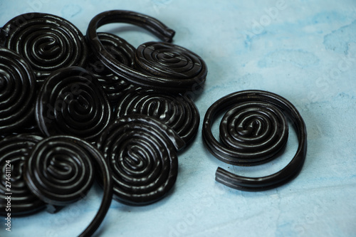 Detail of licorice candy spirals on blue background photo