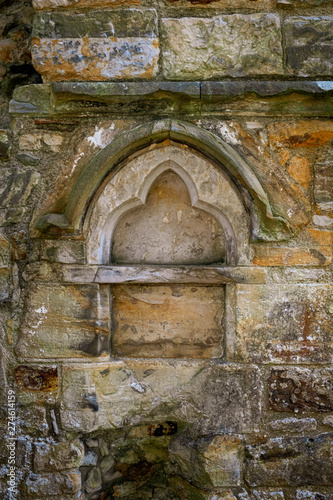 Carved stone within ruined wall