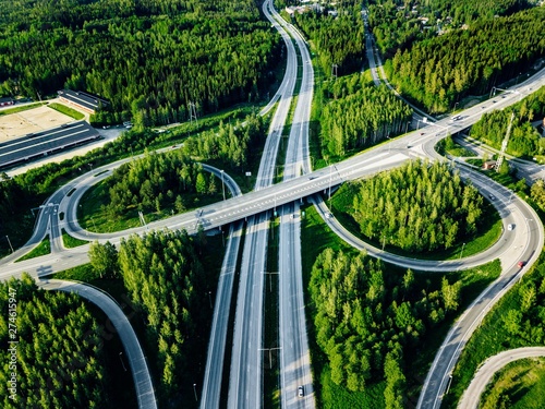 Canvas-taulu Aerial view of highway and overpass with green woods in Finland.