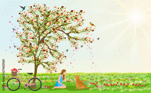 Women and dogs sit under the flower tree. There are bicycles beside them. There are grasslands and flowers in the background. The sun is sparkling in the sky.