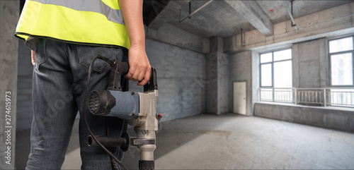 Construction Worker in front of construction site