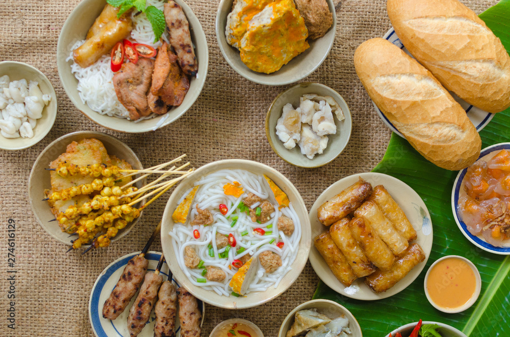 Vietnamese food background with spring roll, banh mi, banh canh, steamed fish ball, shrimp dumpling. Typical cuisine of south central of Vietnam like Binh Thuan, Ninh Thuan, Nha Trang province