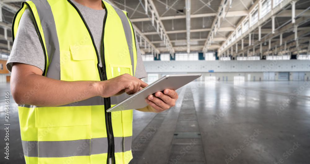 worker hand holding pad for check order pick time in empty warehouse worker hand holding pad for check order pick time in empty warehouse