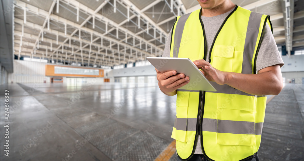 worker hand holding pad for check order pick time in empty warehouse worker hand holding pad for check order pick time in empty warehouse