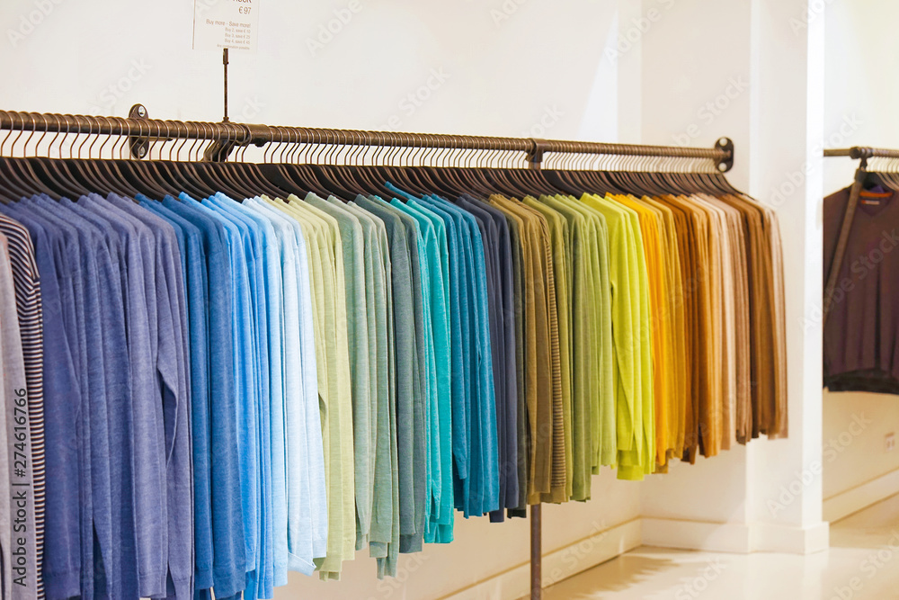 Fashionable clothing on hangers in shop. sport of T Shirts are