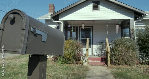 Single family starter home and US mailbox - establishing shot