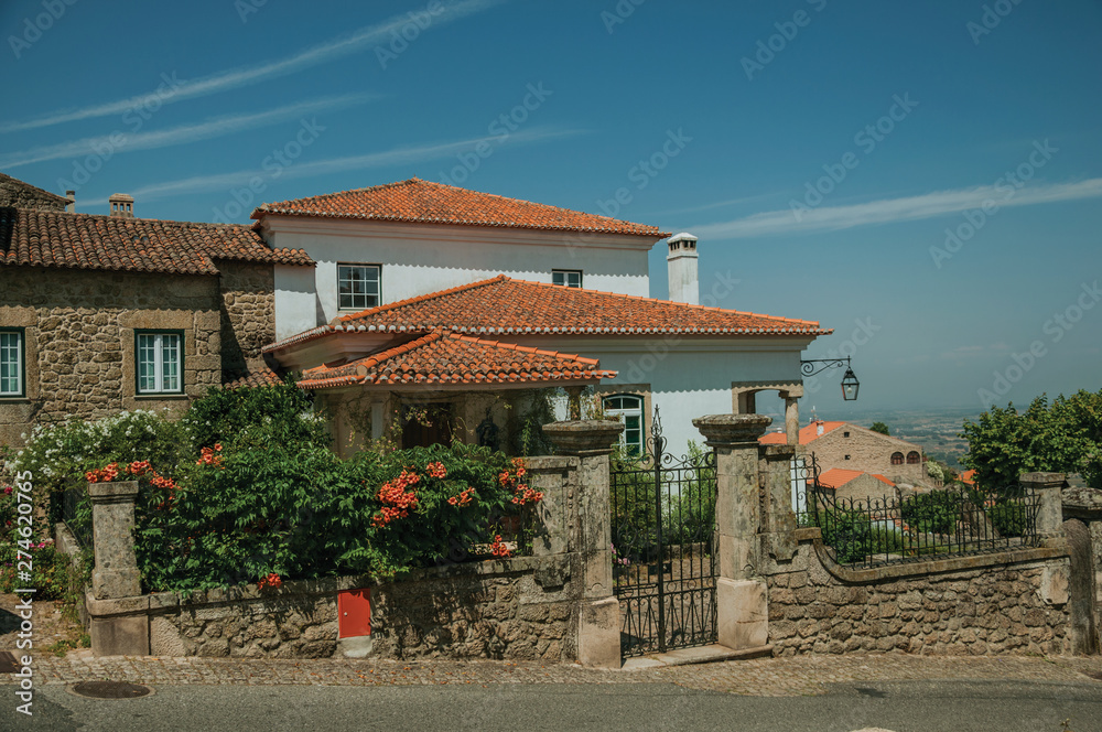 Charming old house with flowered bushes in Monsanto