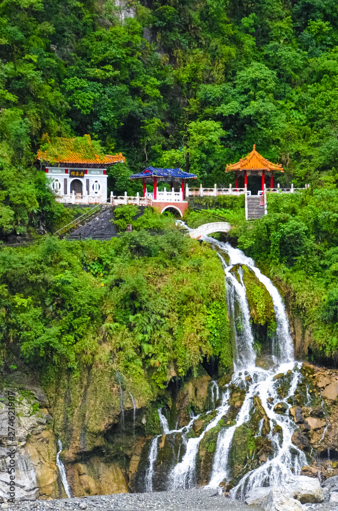 Changchun temple, landmark and a memorial shrine complex in Taroko National Park in Taiwan. The monument is located right above the beautiful waterfall streams. Tropical forest around. Rocks