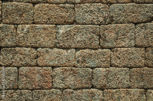 Old wall made of stone bricks forming a charming background