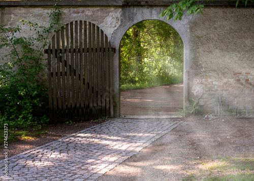 Fotografie, Obraz A new possibility - an open gate with inviting light coming through it