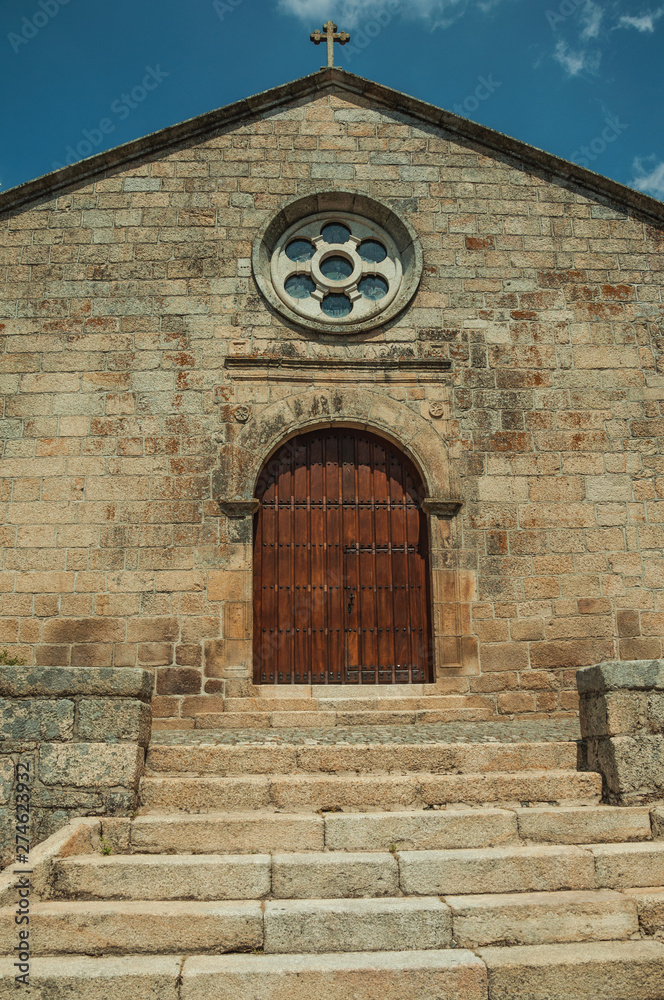 Medieval church facade with stone wall at Monsanto