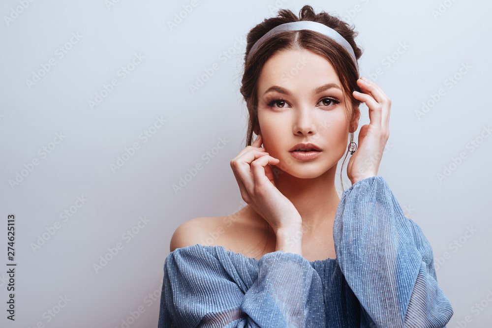 Portrait of young cheerful woman, over grey background Portrait of young cheerful woman, over grey background