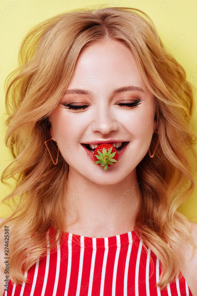 Sexy Woman Eating Strawberry. Sensual Lips. Over vivid yellow background. Beauty Girl Sexy Lips with Strawberry Sexy Woman Eating Strawberry. Sensual Lips. Over vivid yellow background. Beauty Girl Sexy Lips with Strawberry