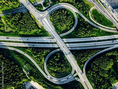 Canvas Print Aerial view of highway and overpass with green woods in Finland.