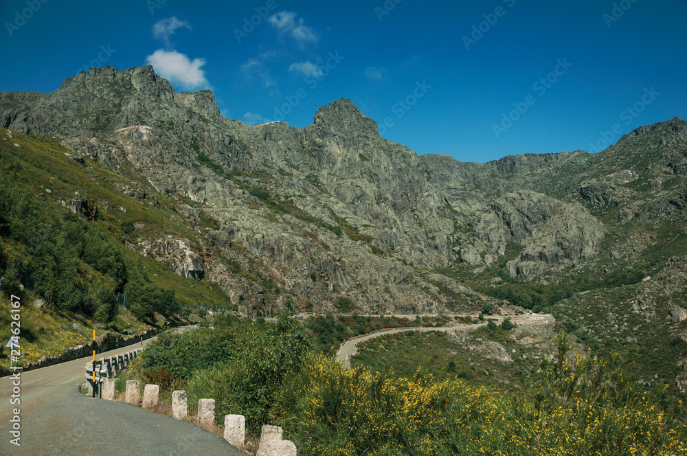 Long roadway passing through rocky landscape