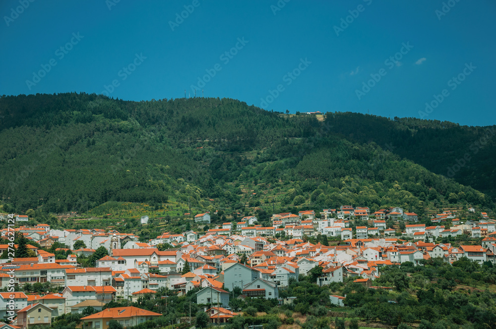 Countryside landscape with white houses on hill