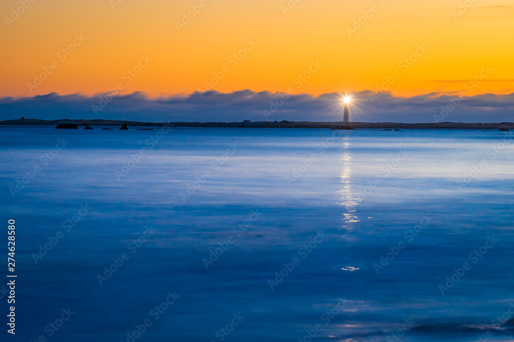 Lighthouse ocean seascape coastline shoreline on Cape Sable Island, Nova Scotia.