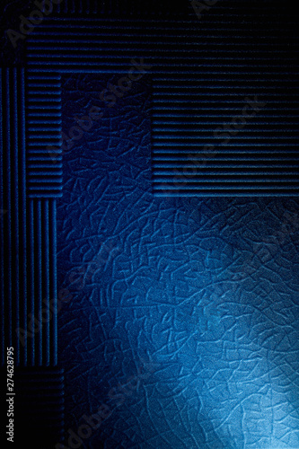 Fototapeta Naklejka Na Ścianę i Meble -  Light blue diagonal diffuse beam of light on a blue background with a pattern