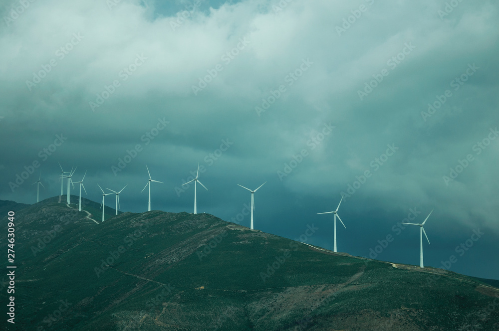 Many wind generators of electric power on hilly landscape