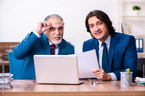 Young and old employees working together in the office  © Elnur