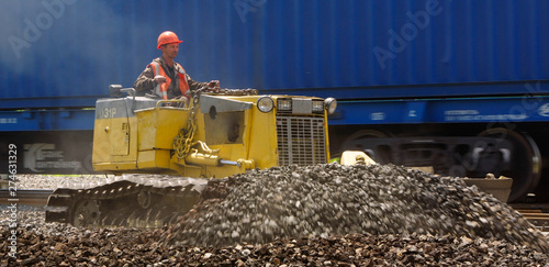 male operator driving excavator on construction building