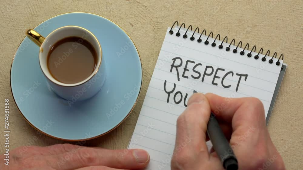 Respect yourself - man hand writing a note with a black marker in a spiral notebook, overhead view Respect yourself - man hand writing a note with a black marker in a spiral notebook, overhead view