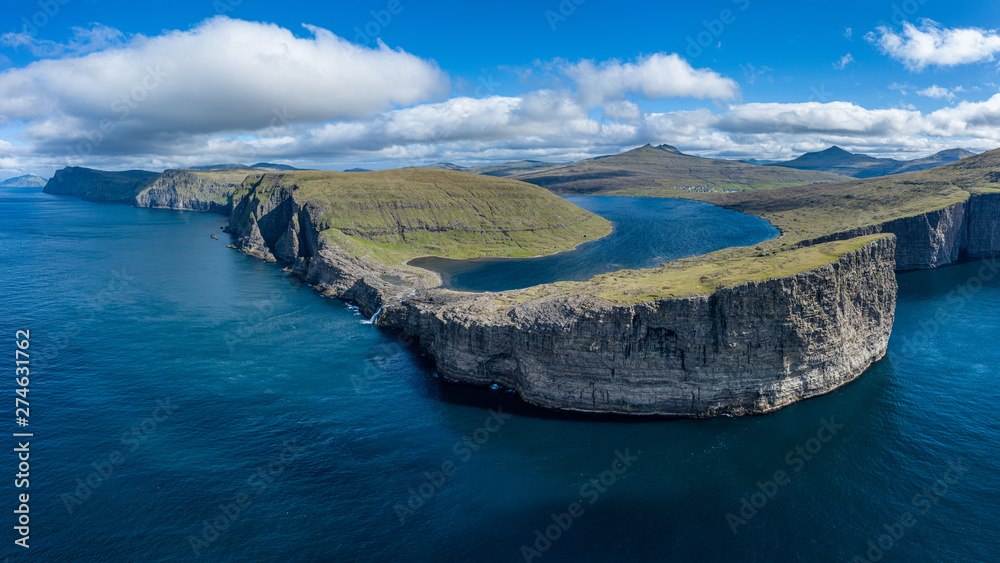 Bosdalafossur waterfall and Sorvagsvatn lake on Vagar island coastline, Faroe Islands