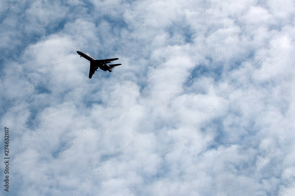 the plane flies across the blue sky the plane flies across the blue sky