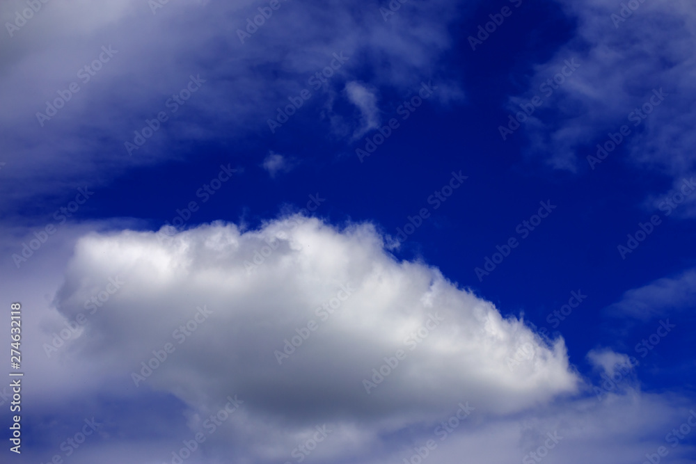 white clouds in bright blue sky