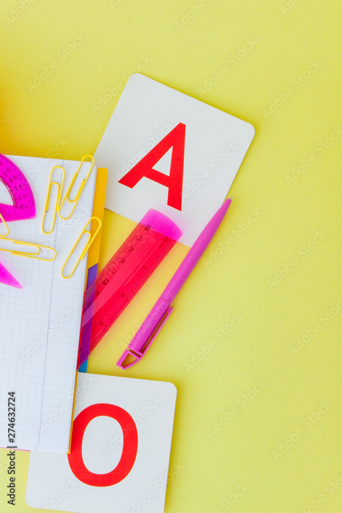Back to school concept with space for text. Top view. Copy space. School office supplies.Creative desk with colourful stationery. Colored paper clip.School supplies on yellow background.Office desk Back to school concept with space for text. Top view. Copy space. School office supplies.Creative desk with colourful stationery. Colored paper clip.School supplies on yellow background.Office desk