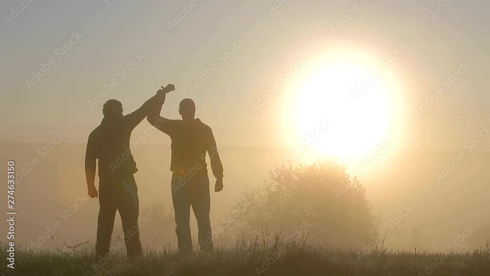 Dark silhouette of a man having fun outdoors at sunrise. Dark silhouette of a man having fun outdoors at sunrise.