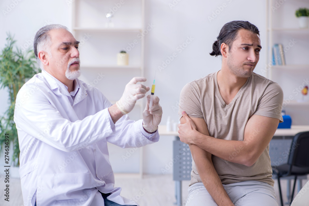 Obraz premium Male patient visitng doctor for shot inoculation 