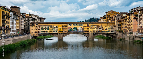 Fototapeta Naklejka Na Ścianę i Meble -  The Ponte Vecchio, or Old Bridge, is a medieval stone arched bridge over the Arno river in Florence, Italy.  It is now a tourist destination with several high end jewelry shops.  