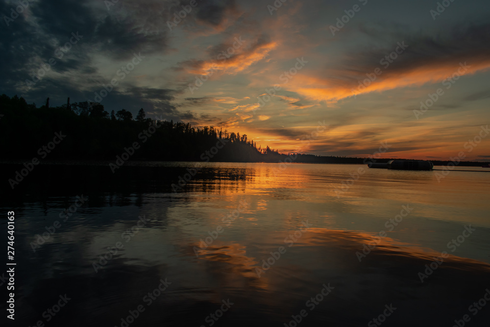 Sunset with clouds reflected on water
