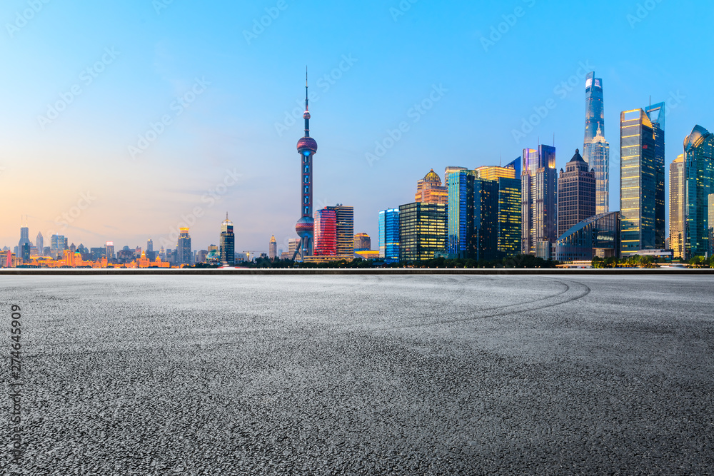 Asphalt race track and modern skyline and buildings in Shanghai at sunset