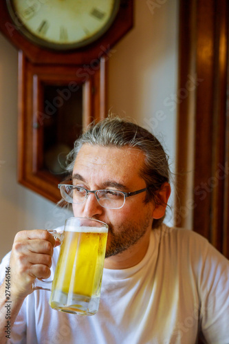 Handsome man is drinking beer in bar