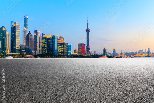 Shanghai modern commercial buildings and empty asphalt road at sunset,China