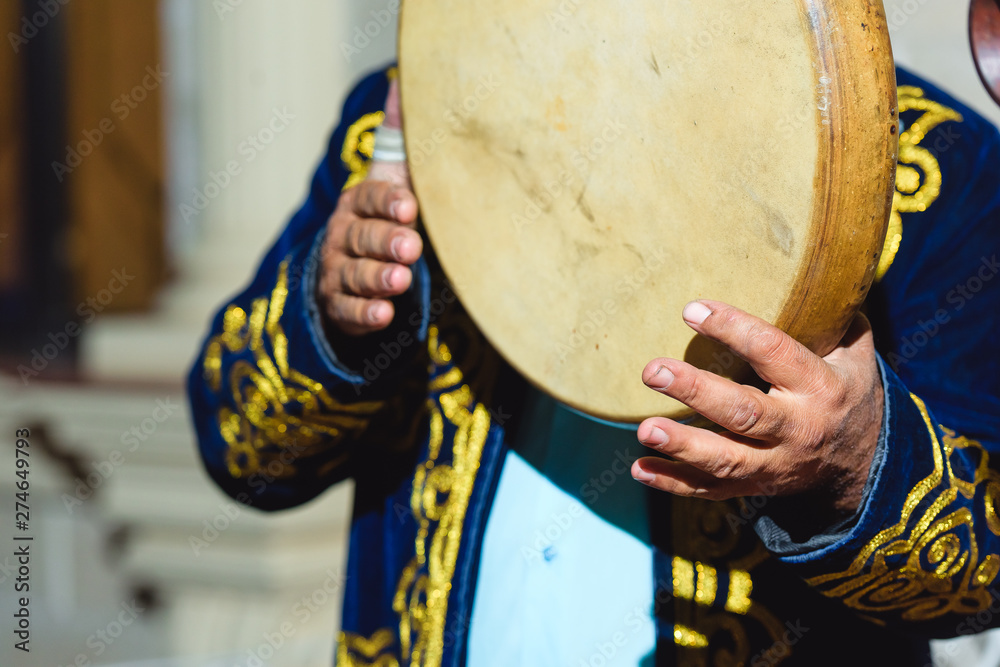 Doira at the Uzbek wedding. Round wooden musical drum. National