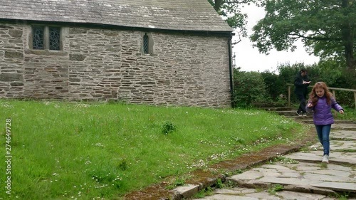 Tourists at the Chapel of Saint Piran is a long construction in Trethevy, in the anglican parish of Tintagel in Cornwall, Uk. Zoom out 4k footage photo