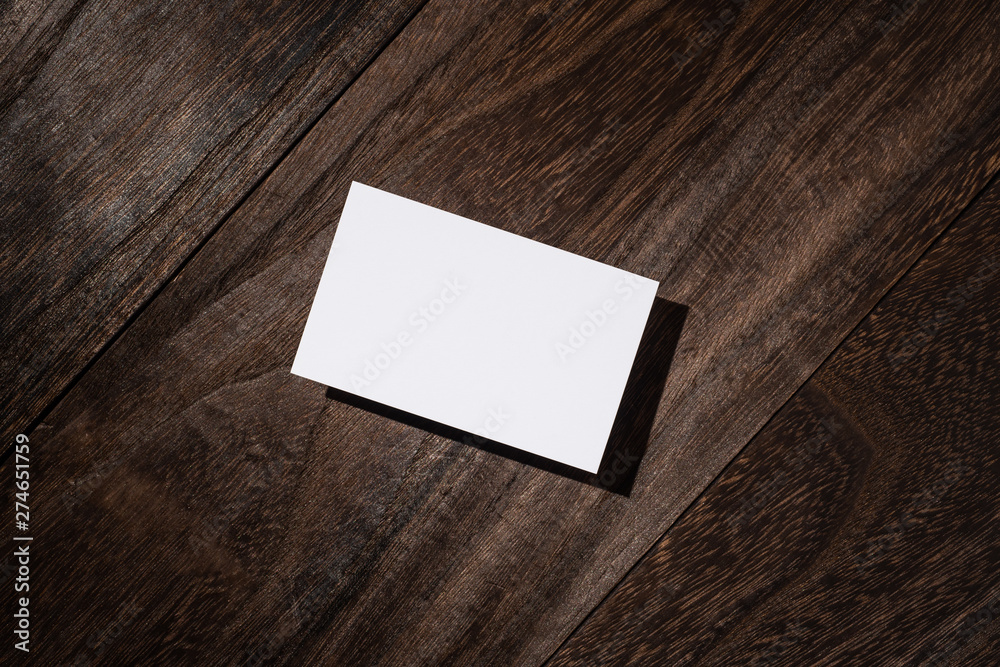 top view of white business card on wood floor top view of white business card on wood floor