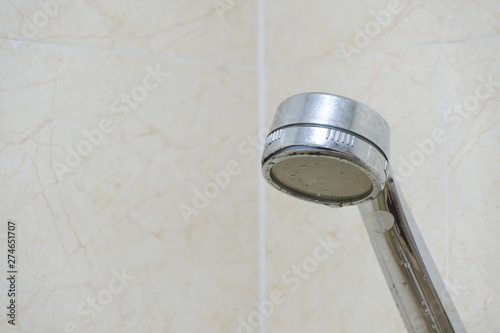 Drops of water from the damaged shower, leak water and rust on the shower tap. Royalty high-quality free stock video footage of damaged leaking water tap hose in the bathroom of house, flat or hotel