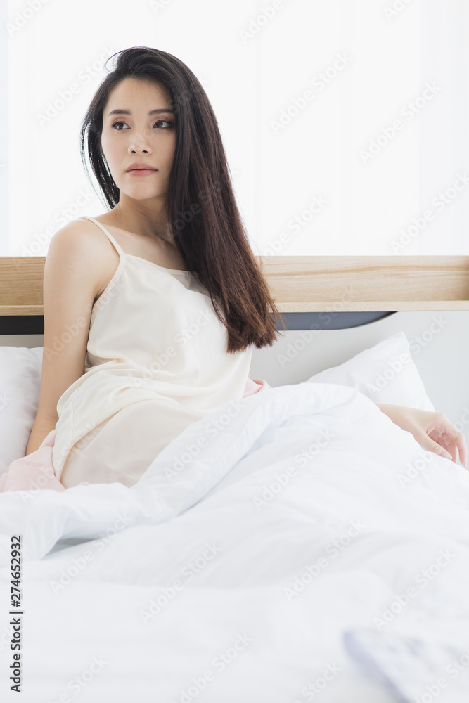  Asian woman model sitting and posing on bed..