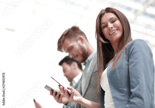 business woman and colleagues using their smartphones